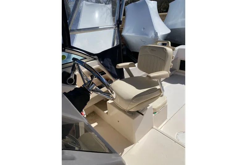 Slide: The Image of 2001 Grady-White Gulfstream 232 boat helm with beige captain's chair and steering wheel. - 4