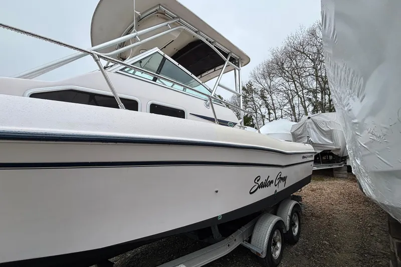 Slide: The Image of 2001 Grady-White Gulfstream 232 boat on trailer, named "Sailor Grey," in storage area. - 6