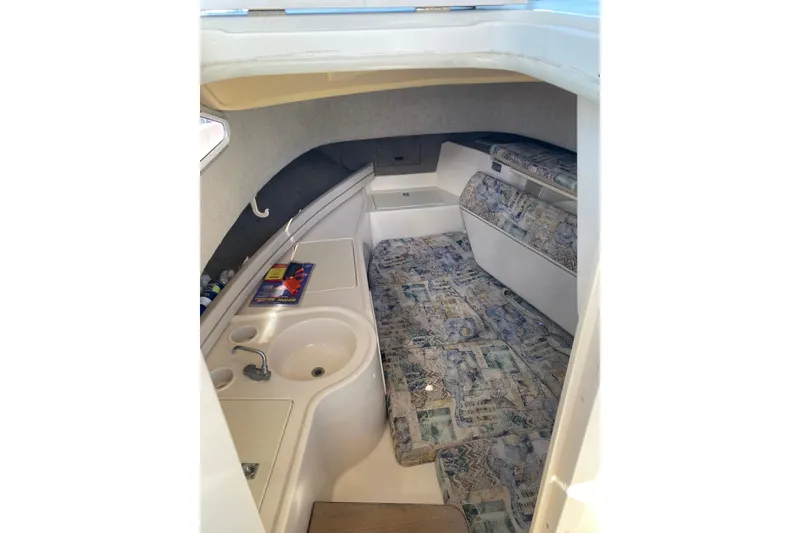 Slide: The Image of 2001 Grady-White Gulfstream 232 cabin interior with sink and patterned seating. - 8