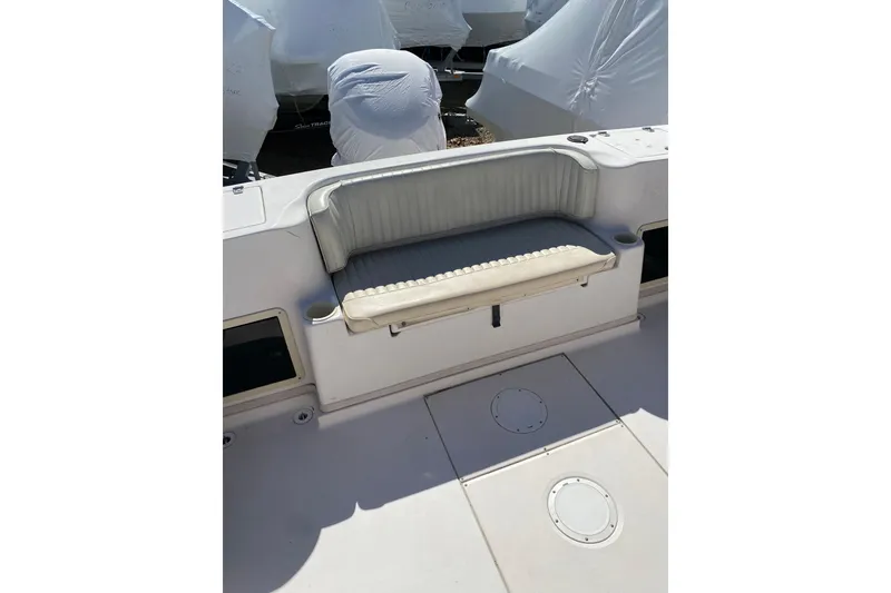 Slide: The Image of 2001 Grady-White Gulfstream 232 boat interior with cushioned seating and storage compartments. - 9
