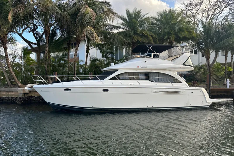 The Image of 2007 Meridian 411 Sedan yacht docked by palm trees, side view. - 0