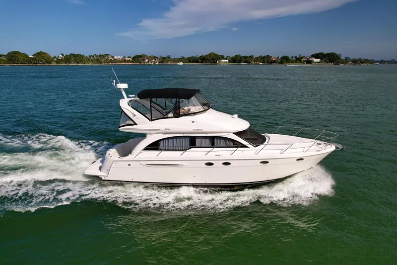 Slide: The Image of 2007 Meridian 411 Sedan cruising on a serene waterway under a clear sky. - 2