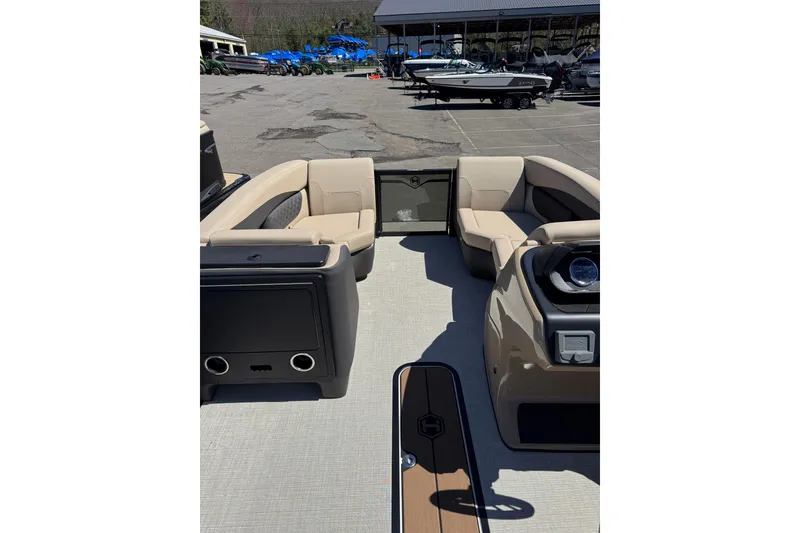 Slide: The Image of 2026 Harris Sunliner 210 boat interior with beige seating and modern dashboard. - 12