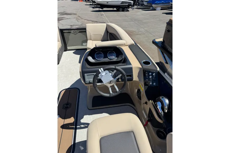 Slide: The Image of Interior view of 2026 Harris Sunliner 210 boat with steering wheel and dashboard controls. - 13