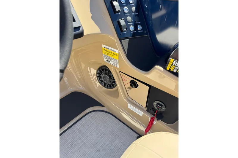 Slide: The Image of Control panel of 2026 Harris Sunliner 210 boat with warning labels and switches. - 14