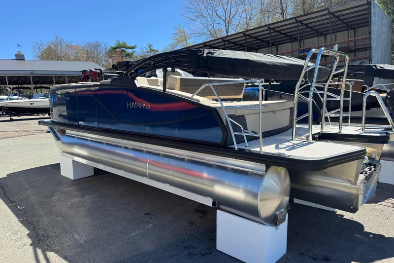 Slide: The Image of 2026 Harris Sunliner 210 pontoon boat displayed outdoors on a sunny day. - 15