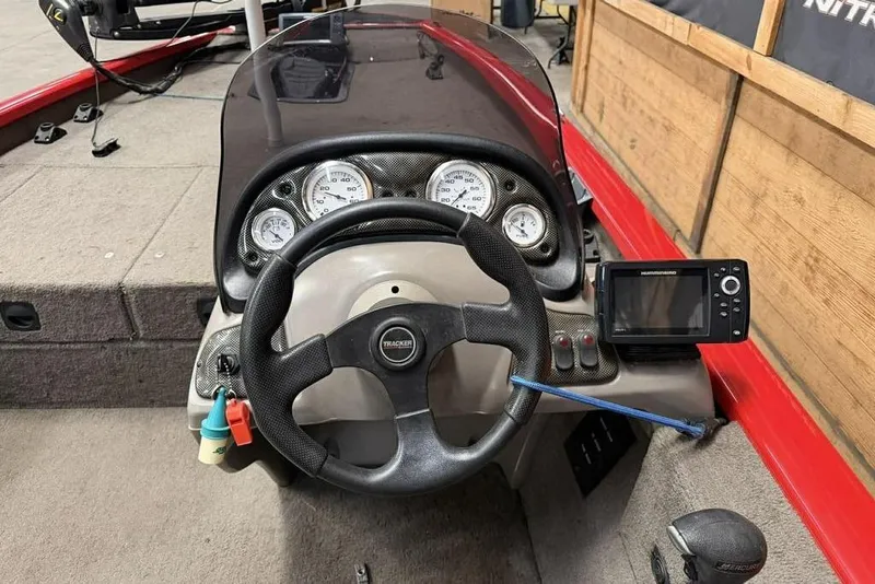 Slide: The Image of 2007 Tracker Pro Team 175 TXW boat dashboard with steering wheel and gauges. - 2
