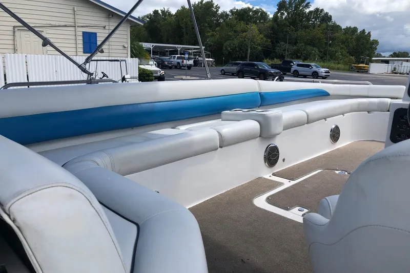 Slide: The Image of 2014 Hurricane SunDeck Sport 201 IO boat interior with white and blue seating. - 14