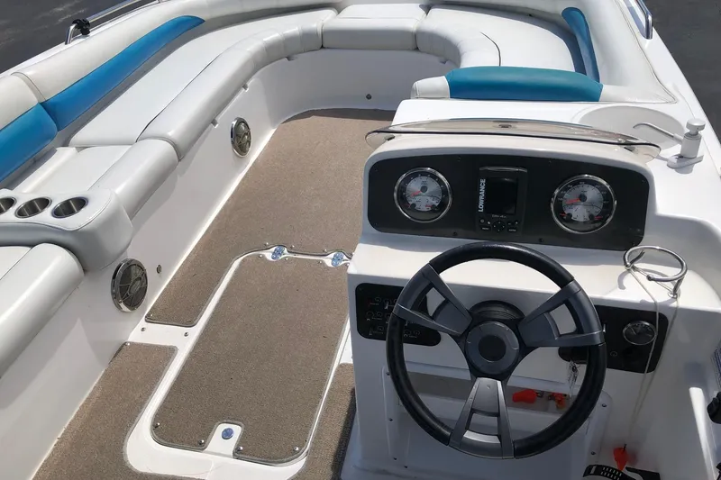 Slide: The Image of 2014 Hurricane SunDeck Sport 201 IO boat interior with steering wheel and seating. - 17