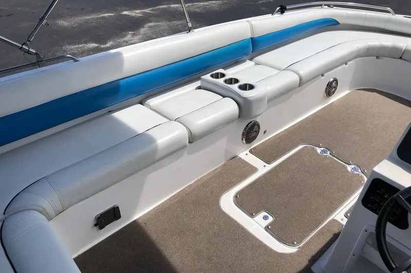 Slide: The Image of 2014 Hurricane SunDeck Sport 201 IO boat interior with cushioned seating and cup holders. - 18