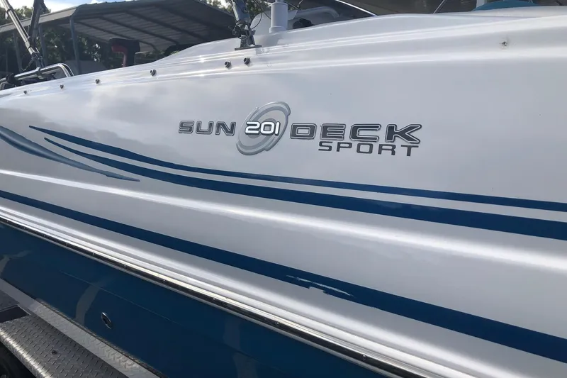 Slide: The Image of 2014 Hurricane SunDeck Sport 201 IO boat with sleek blue and white design. - 2