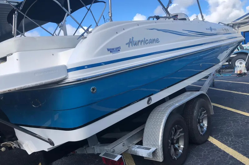 Slide: The Image of 2014 Hurricane SunDeck Sport 201 IO boat on trailer, blue and white design. - 3