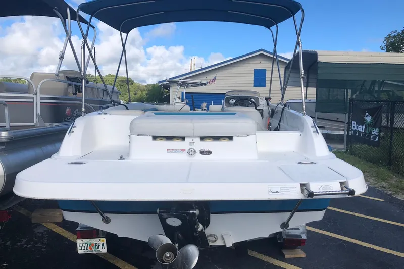 Slide: The Image of 2014 Hurricane SunDeck Sport 201 IO boat with canopy, parked at marina. - 4