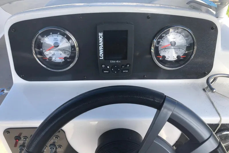 Slide: The Image of 2014 Hurricane SunDeck Sport 201 IO dashboard with gauges and Lowrance Elite-4X display. - 8