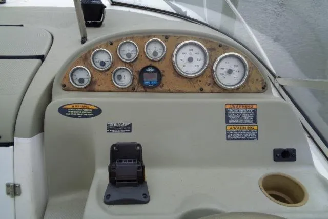 Slide: The Image of Dashboard of a 2000 Bayliner 2455 Ciera Sunbridge boat with gauges and controls. - 13