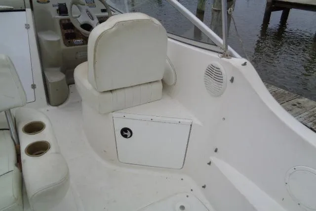 Slide: The Image of 2000 Bayliner 2455 Ciera Sunbridge cockpit with white seating and control panel. - 15