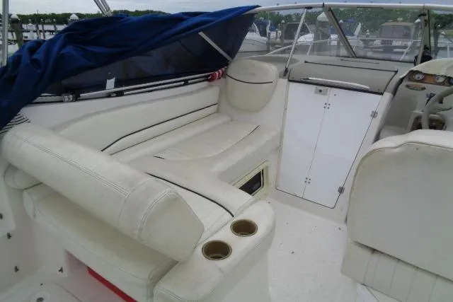 Slide: The Image of 2000 Bayliner 2455 Ciera Sunbridge boat interior with white seating and dashboard. - 17