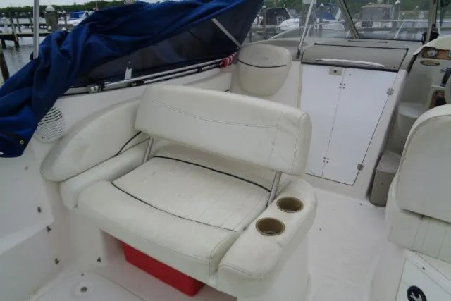 Slide: The Image of 2000 Bayliner 2455 Ciera Sunbridge boat interior with white seating and cup holders. - 18