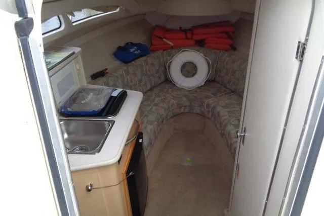 Slide: The Image of Interior of 2000 Bayliner 2455 Ciera Sunbridge with kitchenette and seating area. - 23