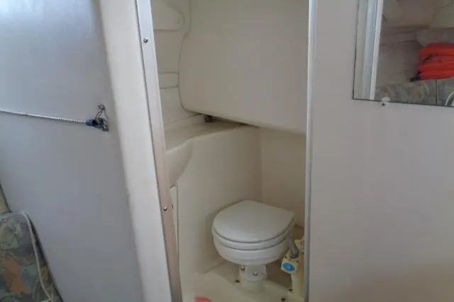 Slide: The Image of Bayliner 2455 Ciera Sunbridge 2000 boat bathroom with compact toilet and mirror. - 30