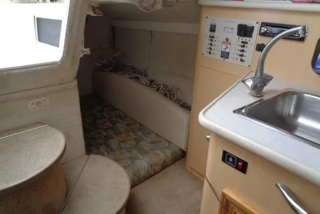Slide: The Image of Interior of 2000 Bayliner 2455 Ciera Sunbridge with kitchenette and sleeping area. - 31
