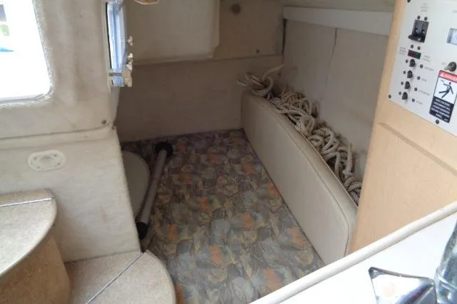 Slide: The Image of Interior cabin of 2000 Bayliner 2455 Ciera Sunbridge with patterned flooring and storage area. - 32