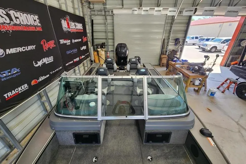 Slide: The Image of 2011 Lund 1975 Pro-V SE boat in a workshop with branded banners. - 3