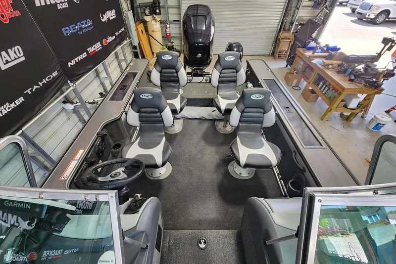 Slide: The Image of Interior of a 2011 Lund 1975 Pro-V SE boat with seating and steering wheel. - 6