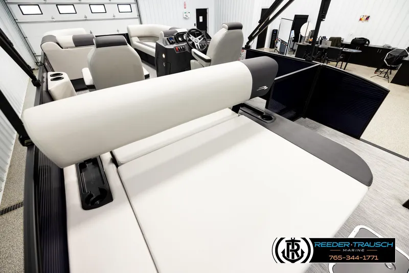Slide: The Image of 2026 Bennington 22 SSBSF pontoon boat interior with plush seating in showroom. - 11