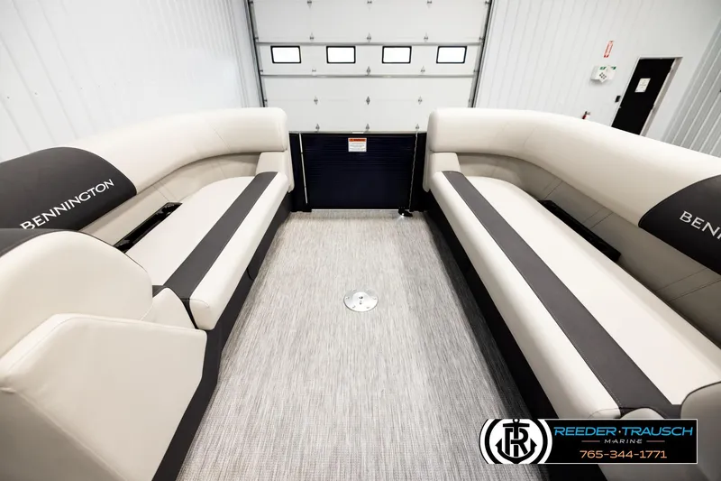 Slide: The Image of 2026 Bennington 22 SSBSF boat interior with beige seating in a showroom. - 18