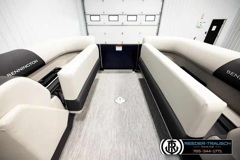 Slide: The Image of 2026 Bennington 22 SSBSF pontoon boat interior with plush seating in showroom. - 20