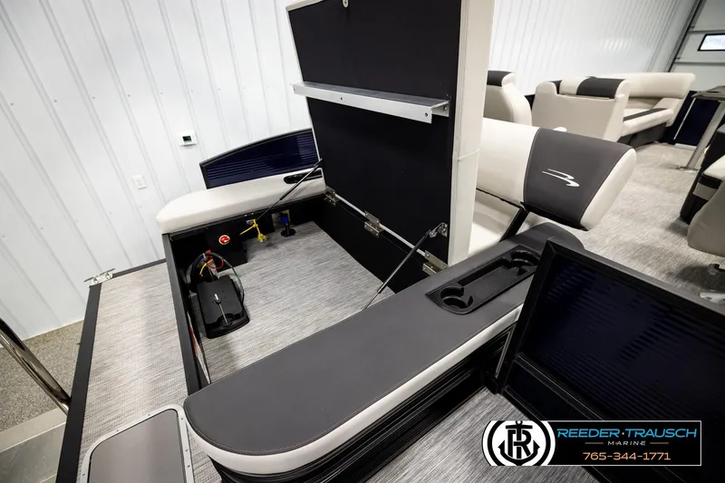 Slide: The Image of 2026 Bennington 22 SSBSF pontoon boat interior with storage compartment open. - 26