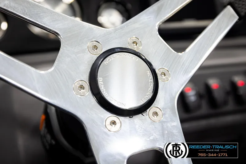 Slide: The Image of Steering wheel of 2026 Bennington 22 SSBSF boat, featuring sleek metallic design. - 31