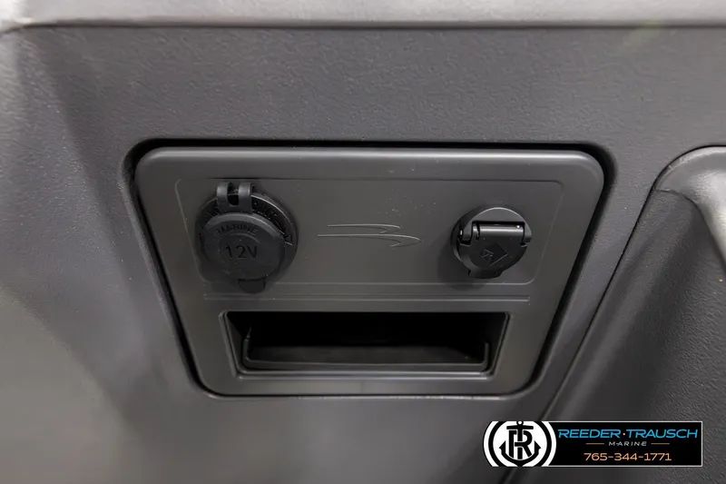 Slide: The Image of 2026 Bennington 22 SSBSF dashboard with 12V marine power outlet and accessory port. - 37