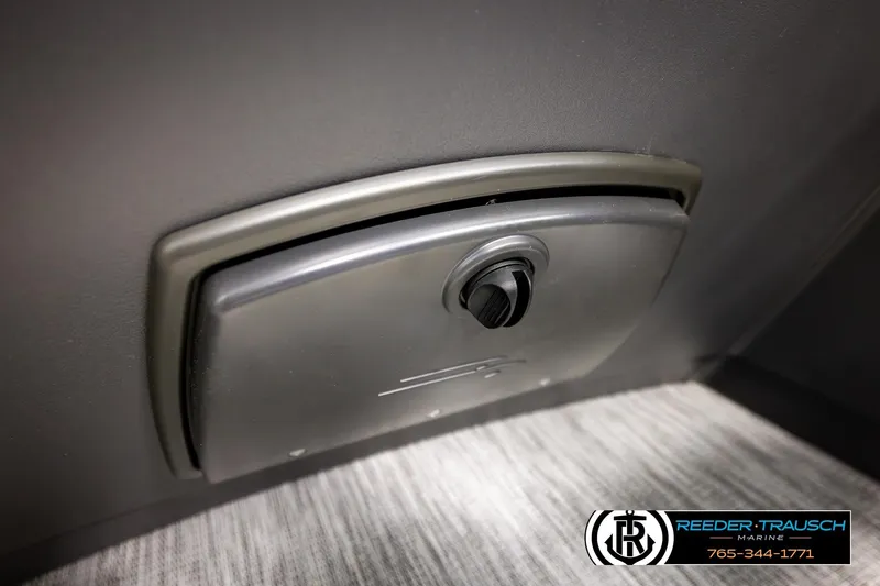 Slide: The Image of Storage compartment on a 2026 Bennington 22 SSBSF boat, featuring a secure latch. - 38