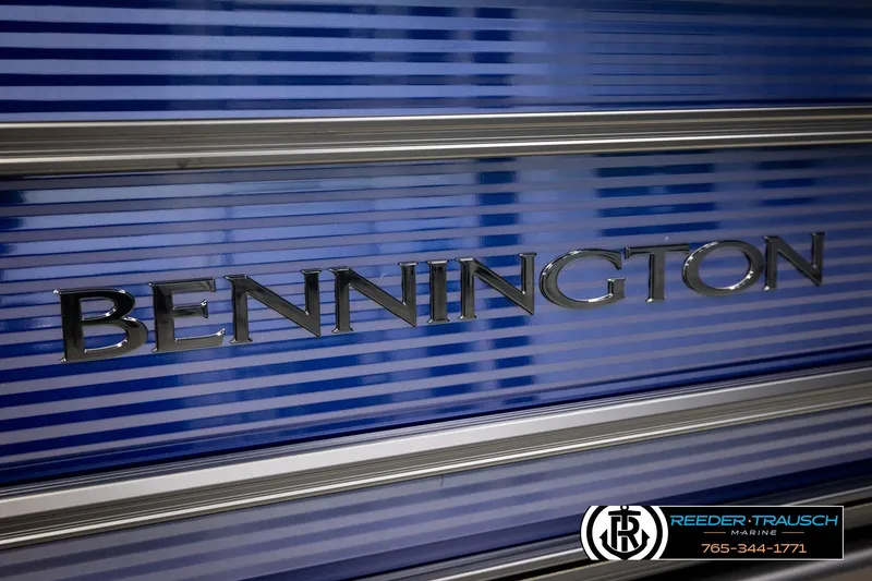 Slide: The Image of 2026 Bennington 22 SSBSF boat with sleek blue-striped design and chrome lettering. - 51