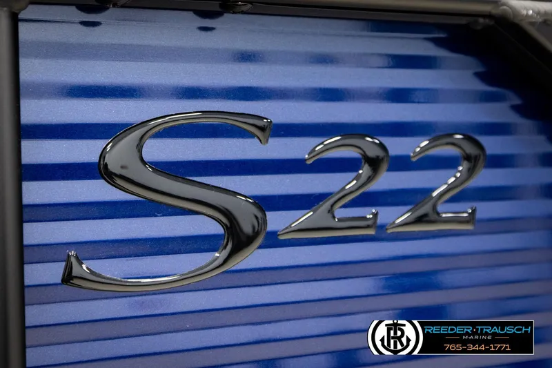 Slide: The Image of 2026 Bennington 22 SSBSF boat emblem on blue-striped background, Reeder-Trausch Marine branding. - 52