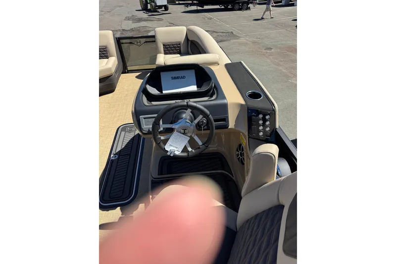 Slide: The Image of 2026 Harris Sunliner 230 Sport pontoon boat displayed outdoors under clear blue sky. - 2