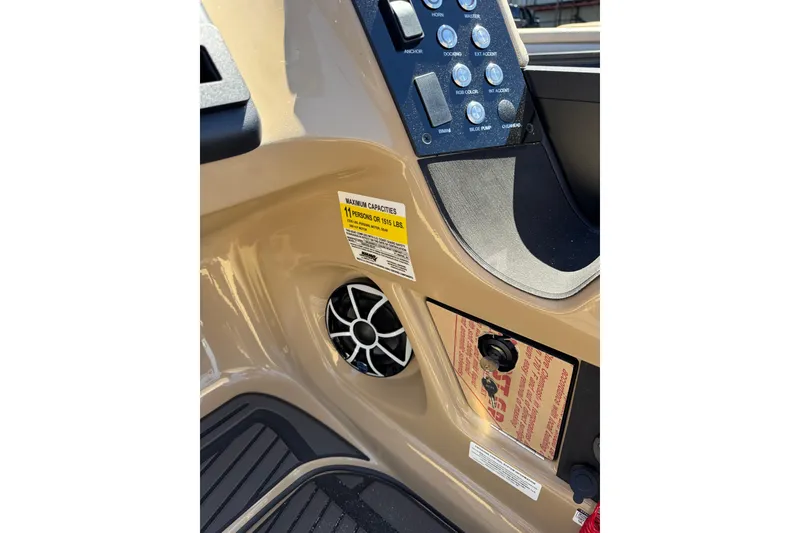 Slide: The Image of Control panel of 2026 Harris Sunliner 230 Sport boat with capacity label and speaker. - 9