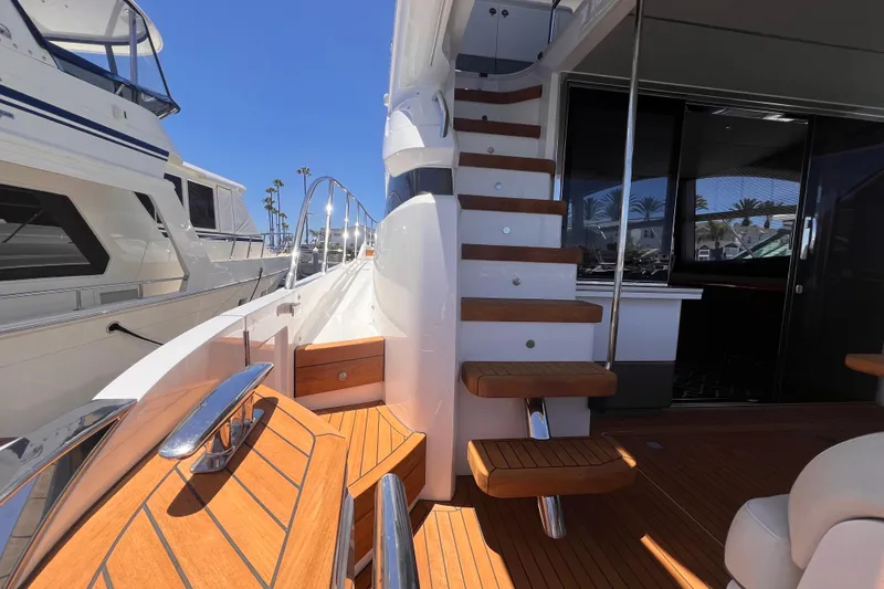 Slide: The Image of Luxurious 2019 Princess F55 yacht with elegant wooden deck and modern staircase design. - 30