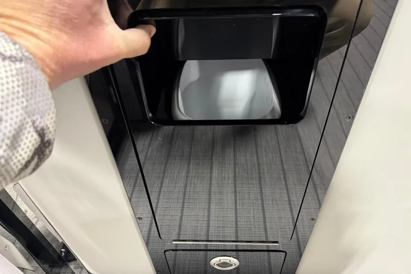 Slide: The Image of Hand opening compartment on 2025 Balise Horizon 24 boat with sleek interior design. - 15