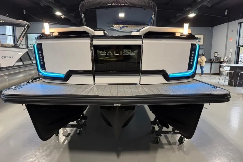Slide: The Image of 2025 Balise Horizon 24 boat with sleek design and blue LED accents in showroom. - 24