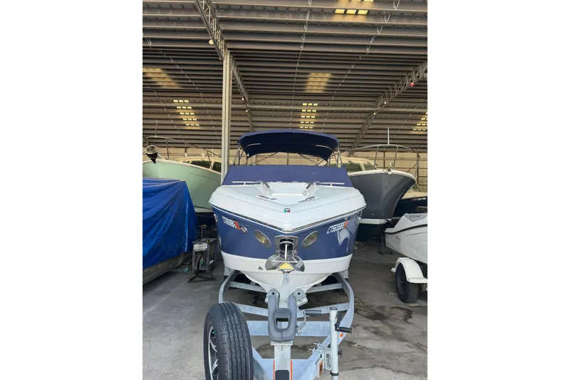 The Image of 2015 Cobalt 243 boat in storage, front view, under covered shelter. - 0