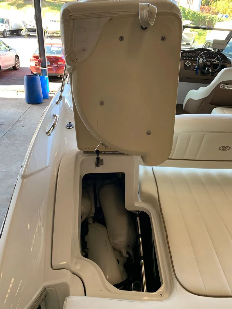 Slide: The Image of Interior of a 2015 Cobalt 243 boat with open seat compartment. - 14