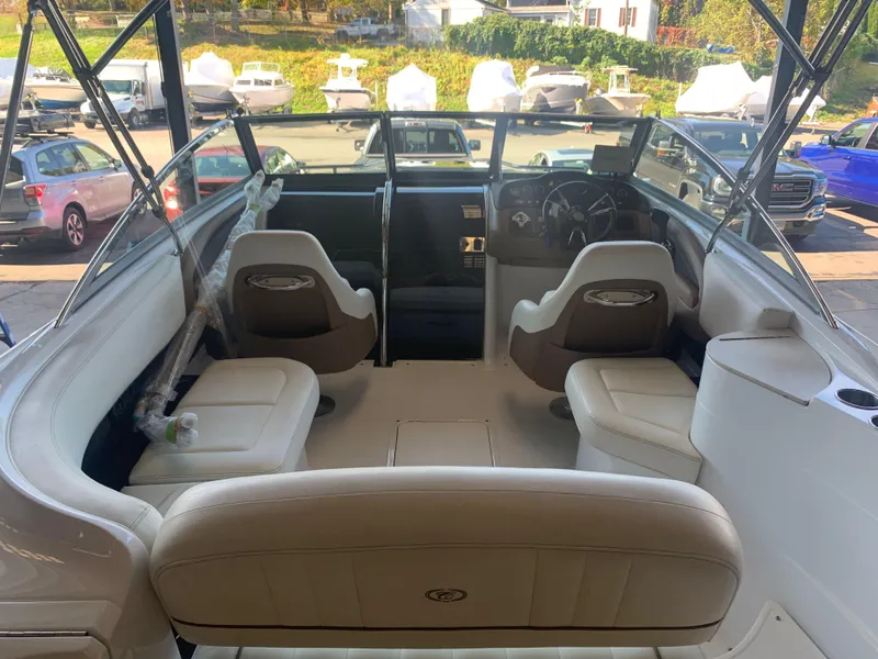 Slide: The Image of Interior of a 2015 Cobalt 243 boat with beige seating. - 15