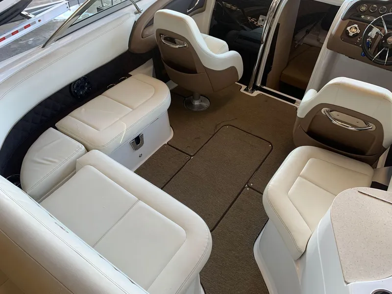 Slide: The Image of Interior of a 2015 Cobalt 243 boat with beige leather seating. - 16