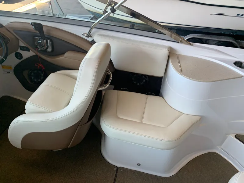 Slide: The Image of Interior of a 2015 Cobalt 243 boat with beige leather seats. - 17