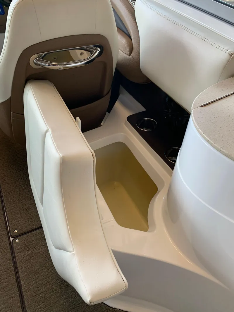 Slide: The Image of 2015 Cobalt 243 boat interior with storage compartment. - 18