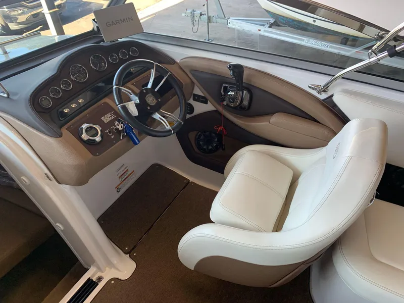 Slide: The Image of 2015 Cobalt 243 boat interior with steering wheel and controls. - 22