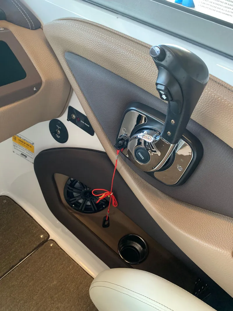 Slide: The Image of Interior of a 2015 Cobalt 243 boat with throttle control. - 25